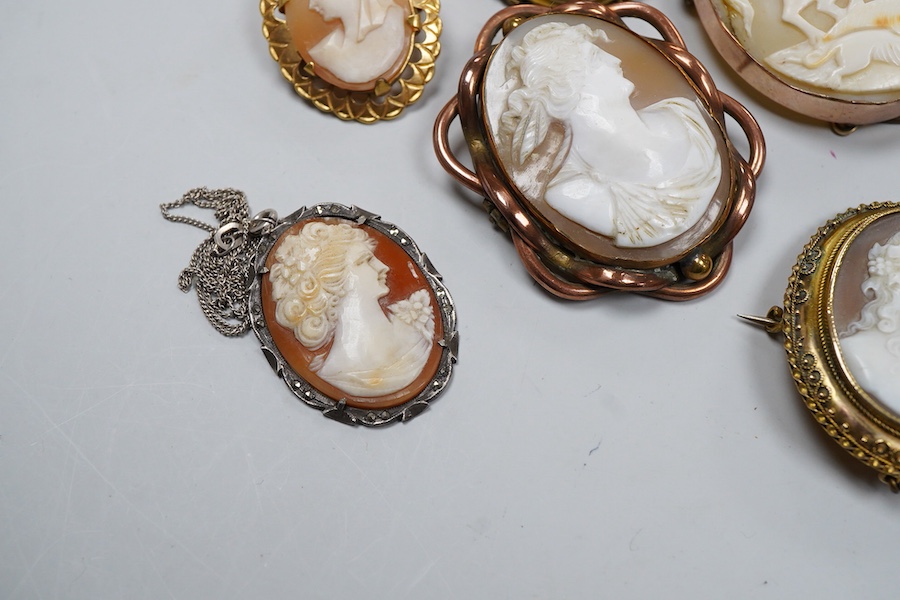 A collection of shell cameo brooches, comprising: a cameo depicting Bacchus, in a gold mount in the Archaeological Revival style, decorated with rope twist and a twisted knife wire border, length 4.4cm; together with sev